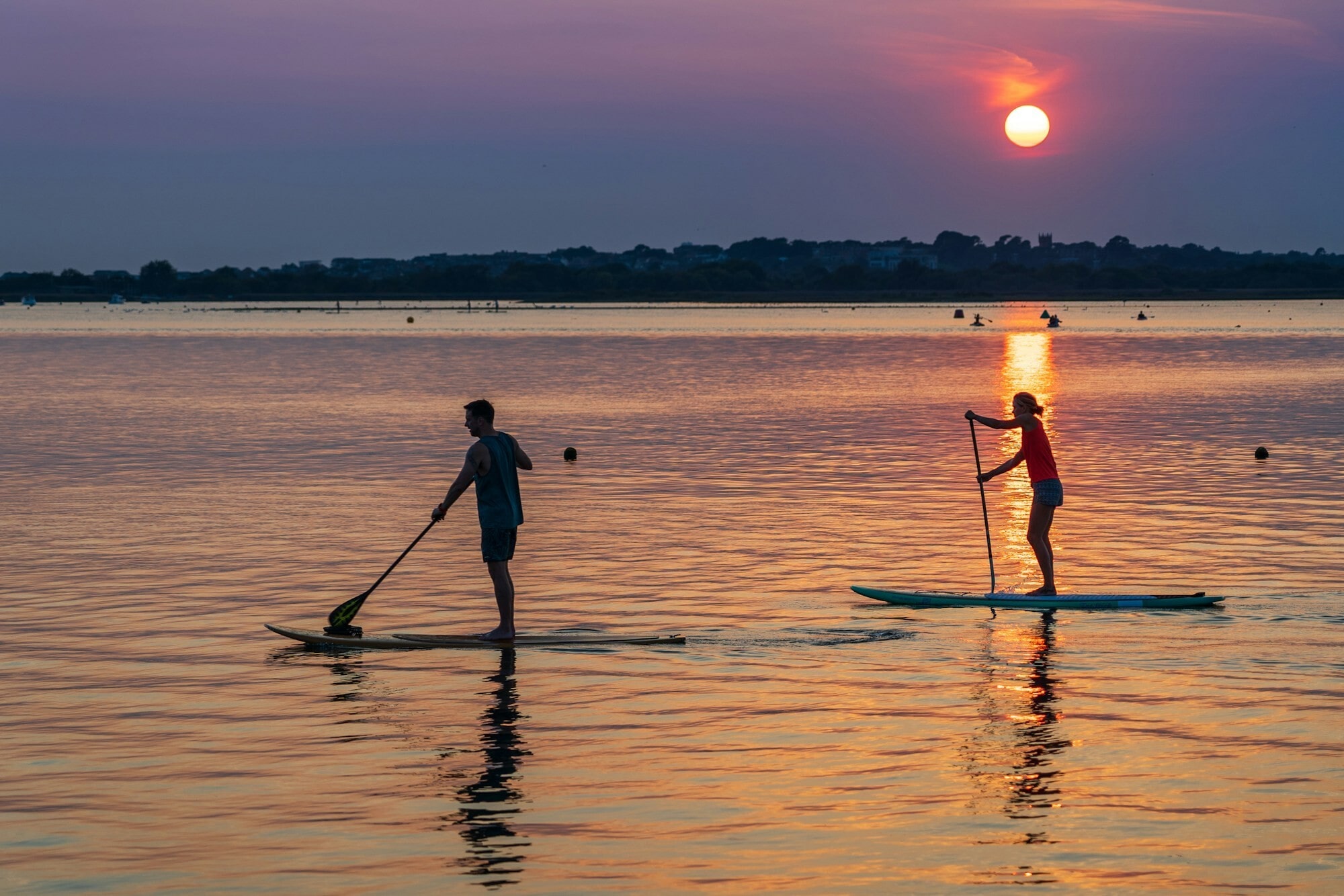 A couple on stand-up paddleboards